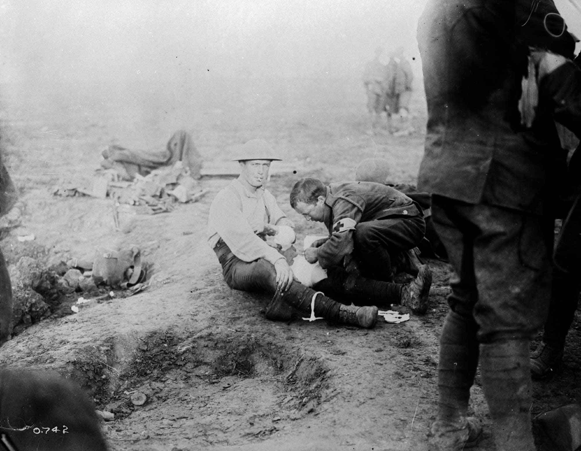 Red cross man dressing a Canadian. September, 1916.